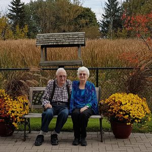 Two Residents siting on a bench outside
